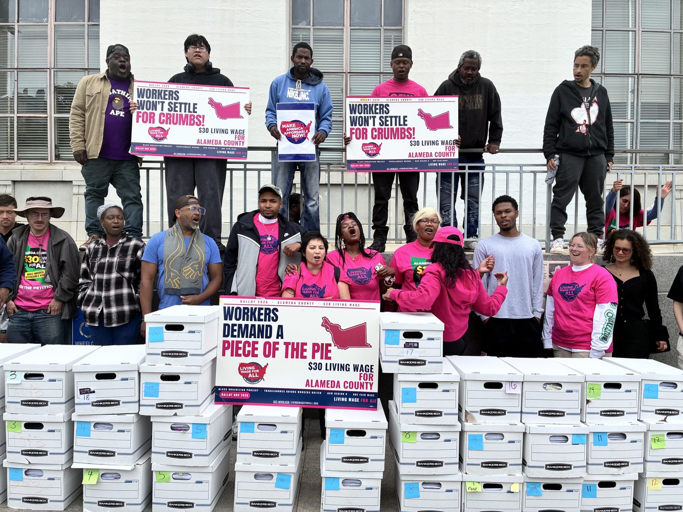 Coalition members from Black Organizing Project, Trabajadores Unidos Workers United, UAW Region 6, and One Fair Wage celebrate the signature turn-in